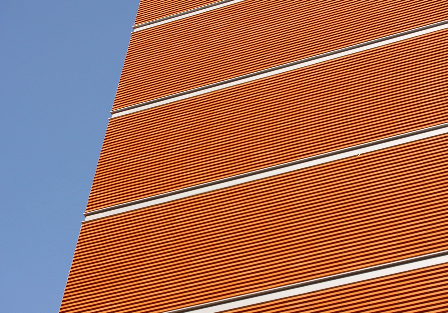 Terracotta louvres against the sky